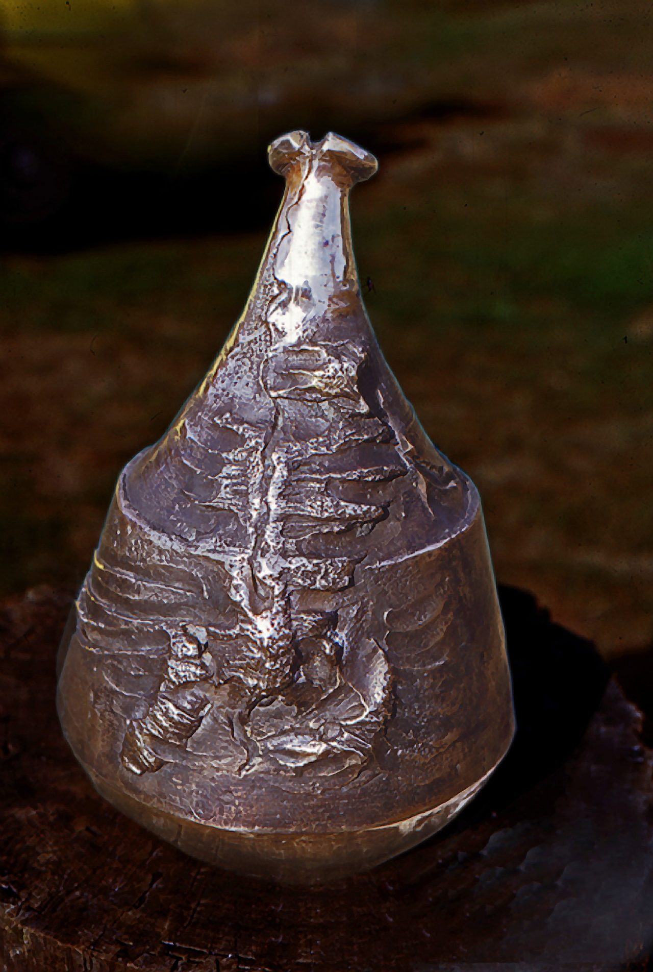 Container Form 2, a gunmetal bronze vessel with a bell-shaped mouth, its polished surface embossed with a ribbed fern-like relief, by David Hamilton