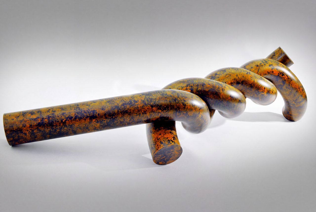 Twist, a long mottled bronze-and-black painted steel rod coiling into three loops, by David Hamilton