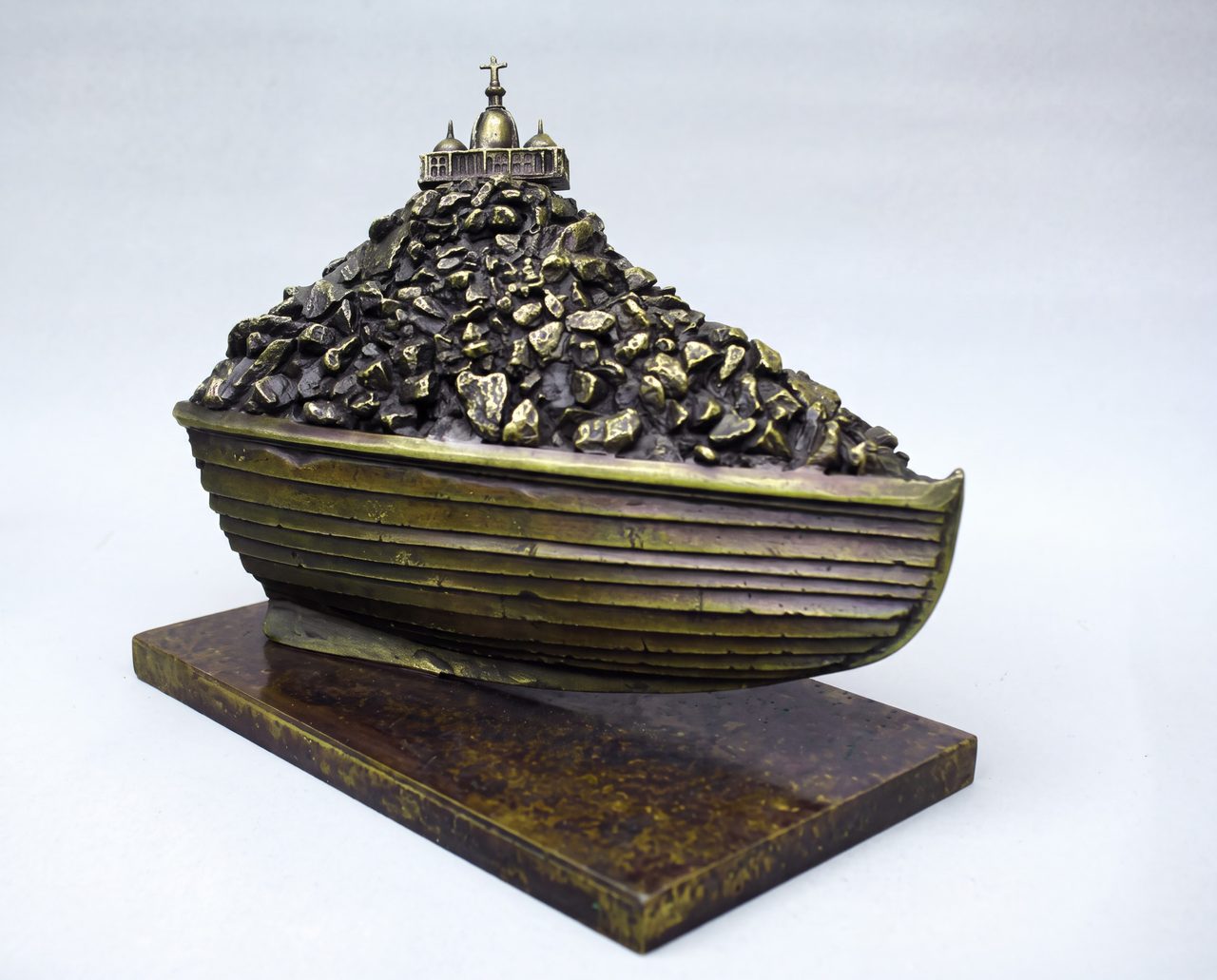 On the Rocks, a bronze boat filled with rubble and topped by a small domed building, by David Hamilton