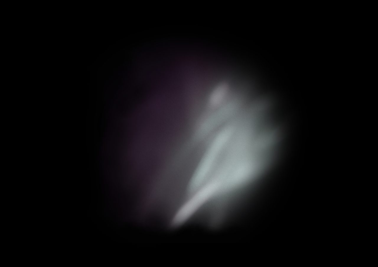 Untitled, an abstract long-exposure photographic study showing a dim white glowing shape against black, by David Hamilton