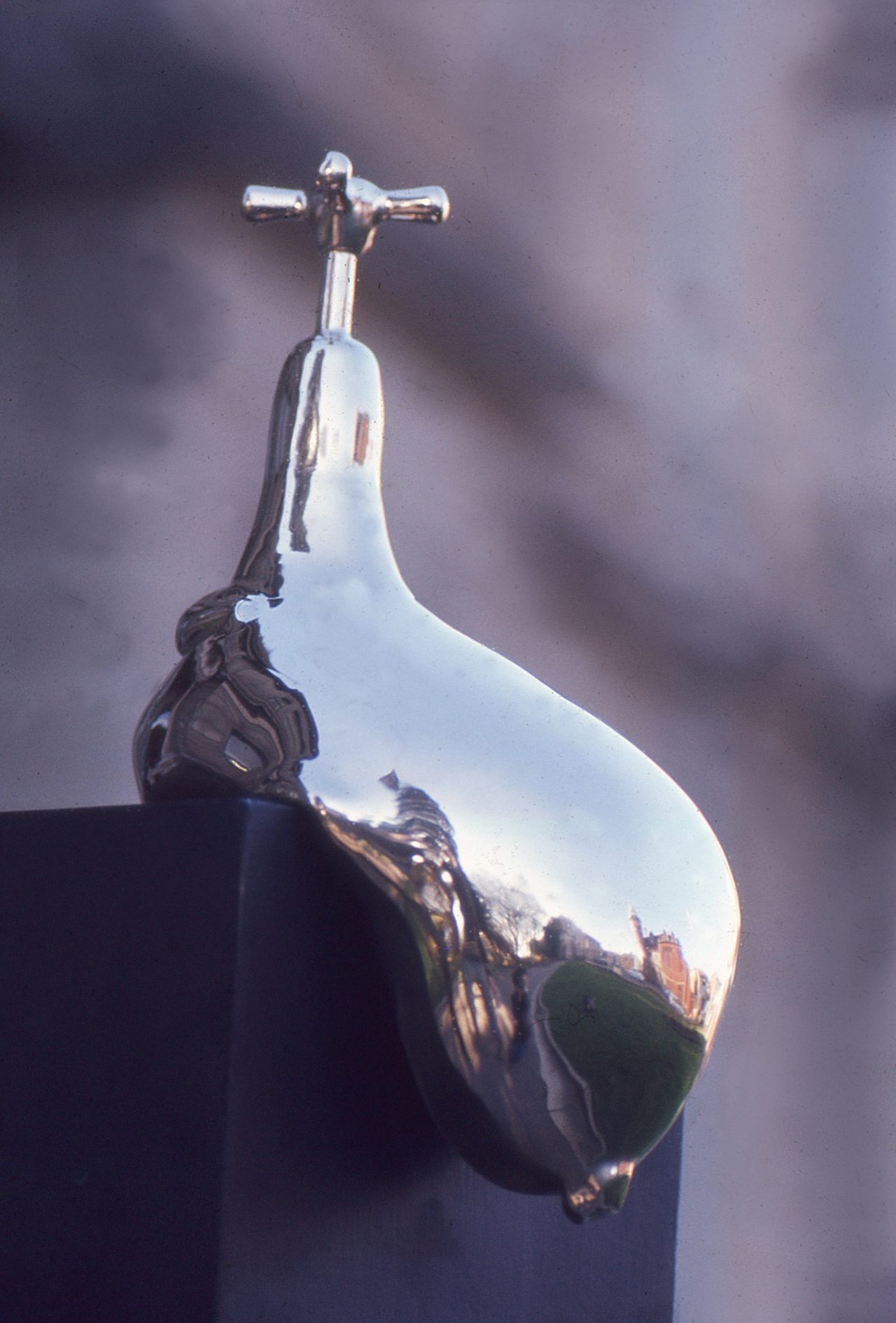 Cold, a polished bronze teardrop form topped by a cross-handled tap, mounted on a dark plinth, by David Hamilton