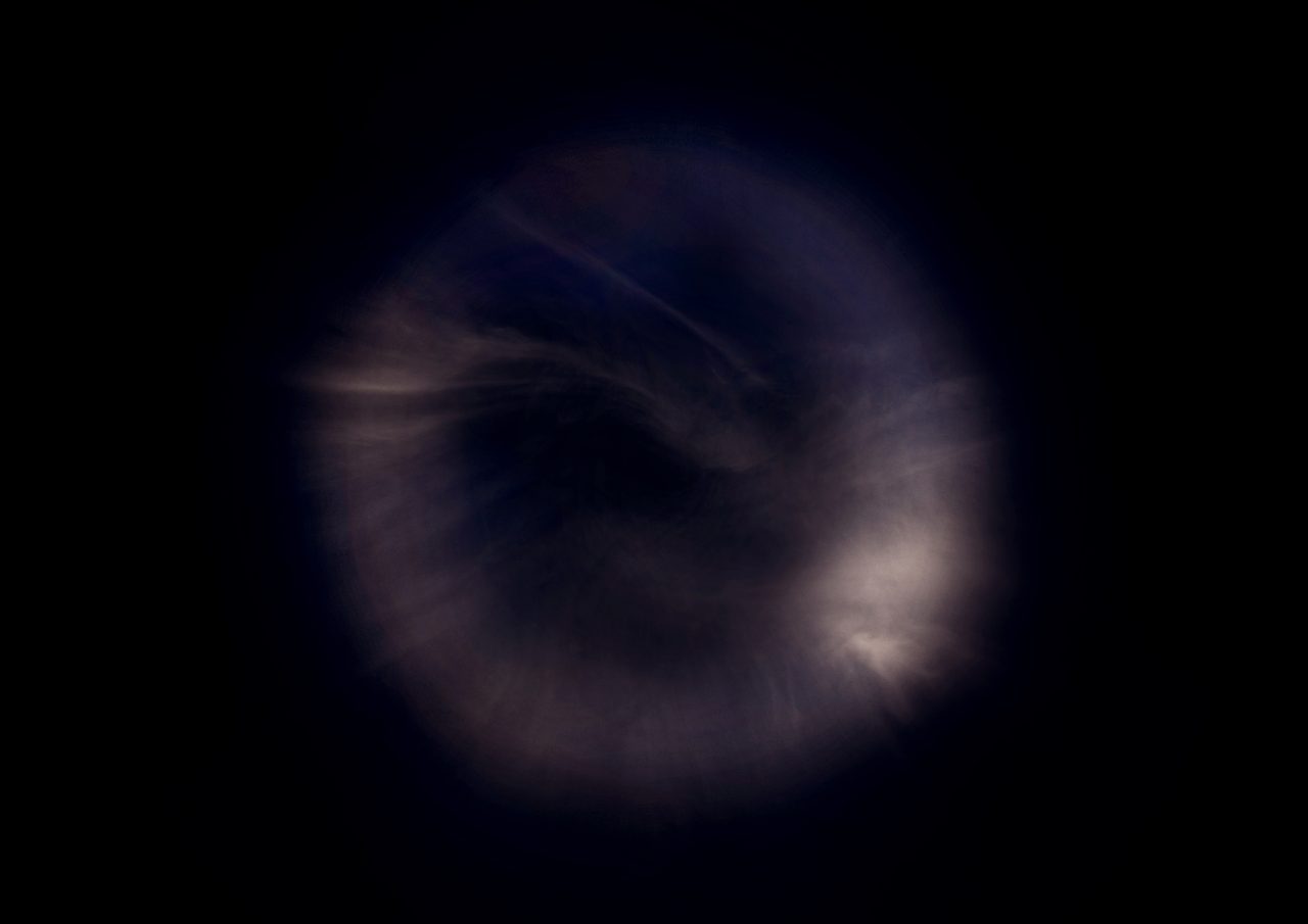 Untitled, an abstract long-exposure photographic study showing a warm orange glow shot through with fine purple streaks against black, by David Hamilton