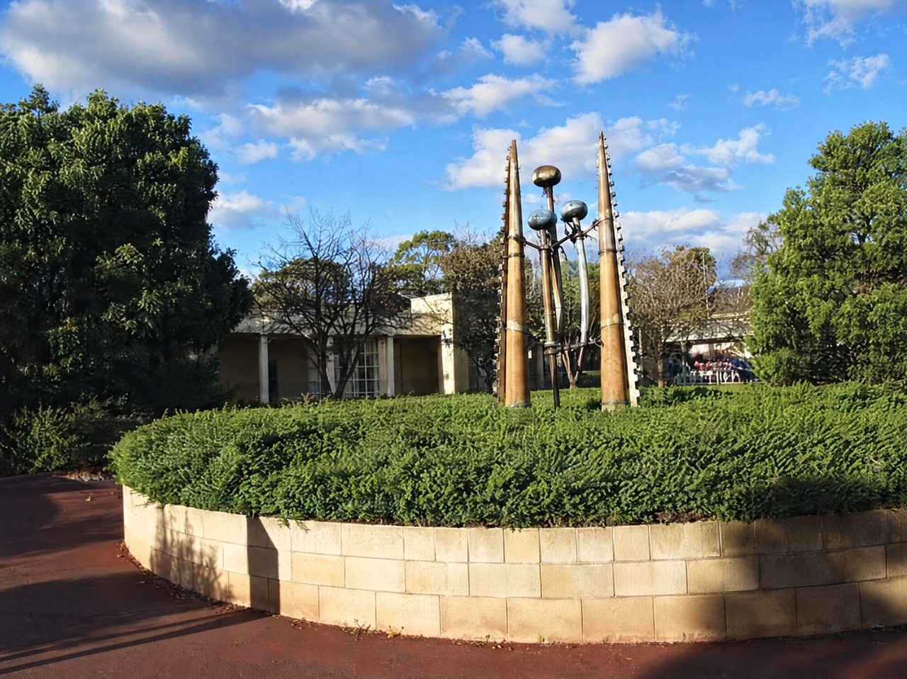 Rack: tall copper-plated steel spires rising from a circular planted bed outside the Rosny library, by David Hamilton