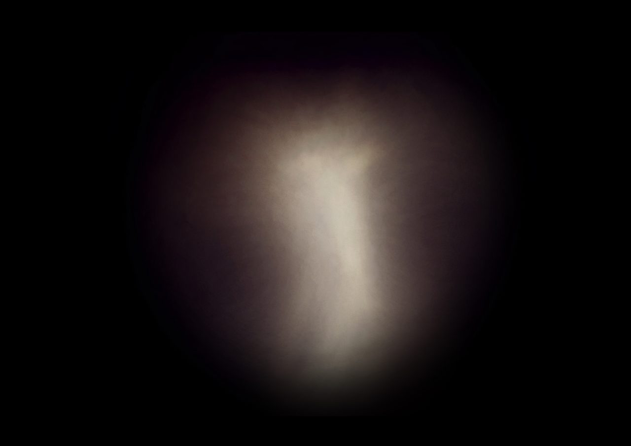 Untitled, an abstract long-exposure photographic study showing a soft brown pillar-like glow against black, by David Hamilton