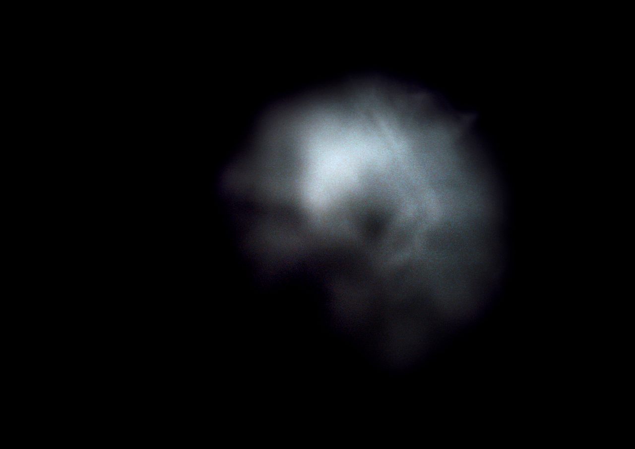 Untitled, an abstract long-exposure photographic study showing a soft grey cloud-like glow against black, by David Hamilton