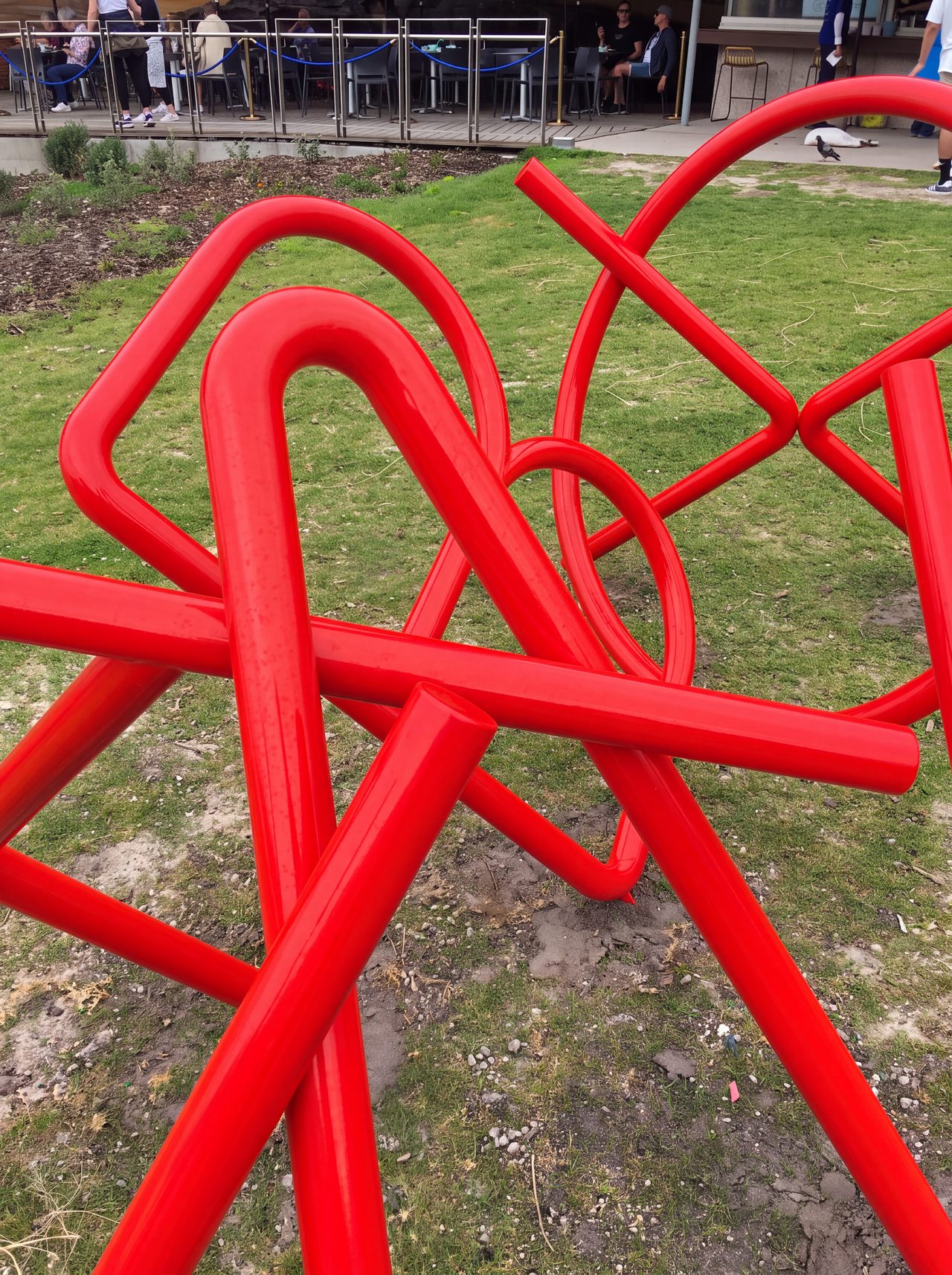Jackinabox, a close view of the looping, crossing red painted steel rods of the large outdoor sculpture, by David Hamilton