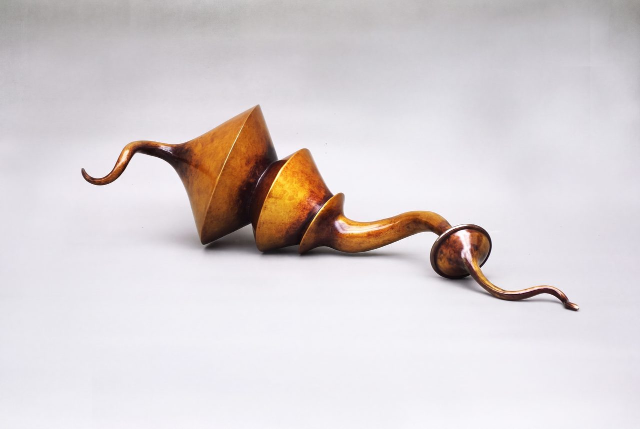 Earthbit, a golden bronze sculpture of stacked cone and funnel forms linked by curling tendrils, by David Hamilton