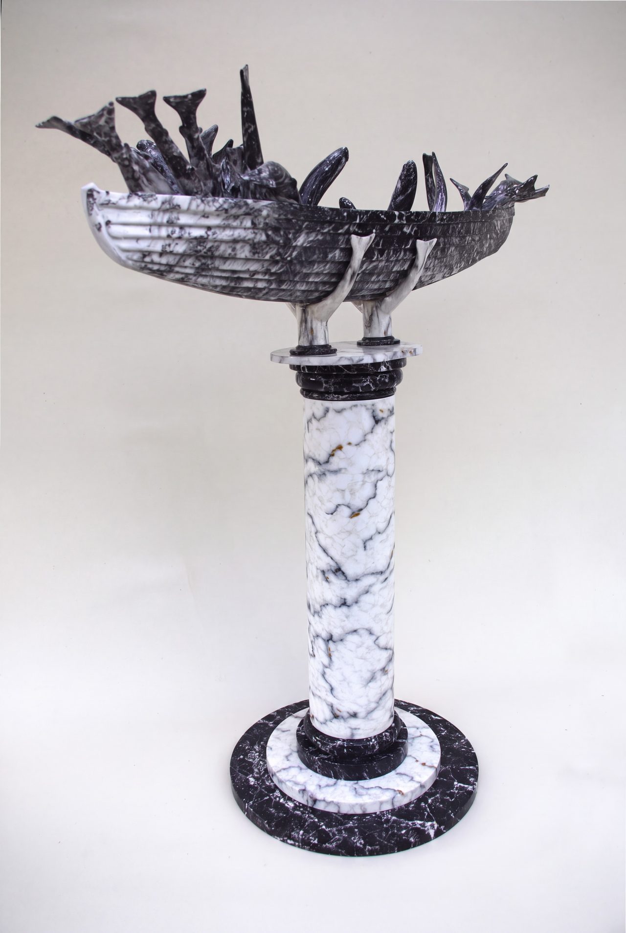 Monument to Okehampton Bay, a marbled boat form bristling with carved fish, mounted on a classical column, by David Hamilton