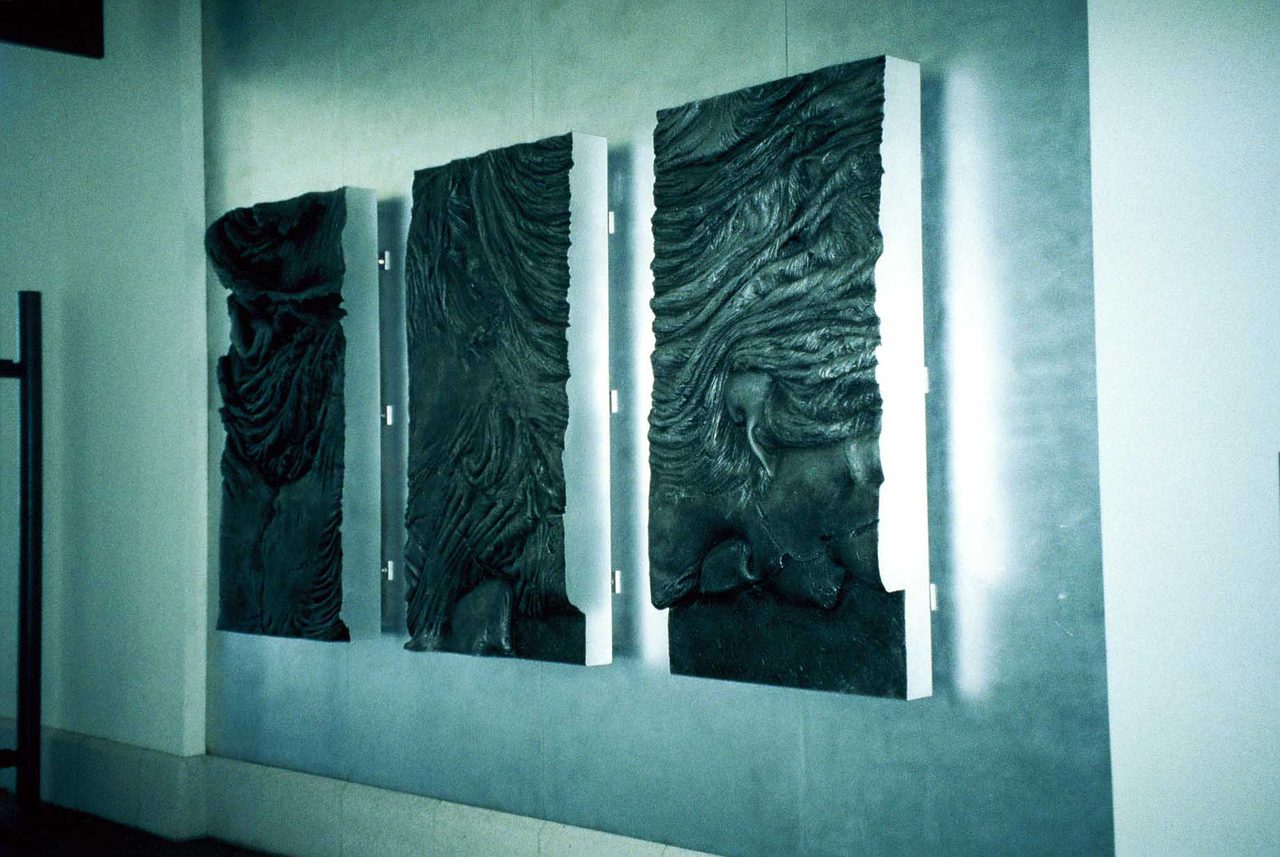Ron Kowalke's Windows of Fire: three cast aluminium panels of lava texture hung on a wall, lit from behind