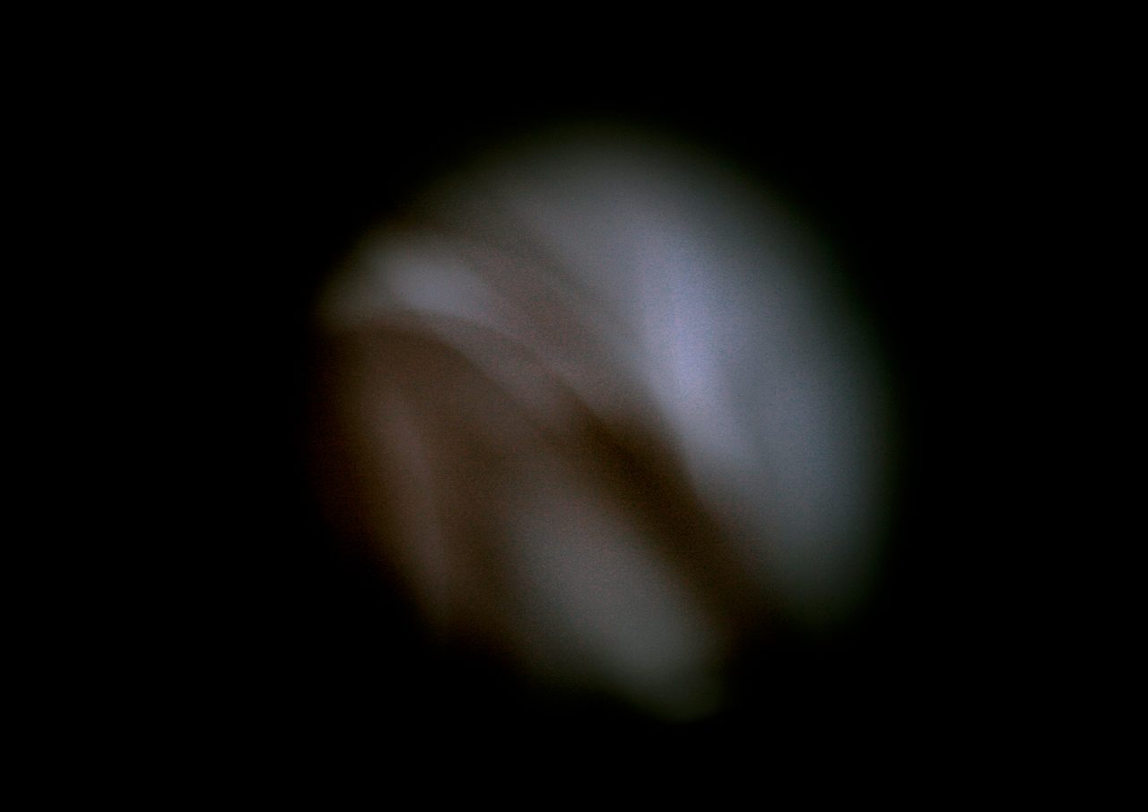Untitled, an abstract long-exposure photographic study showing a pale bluish glow shading into black, by David Hamilton