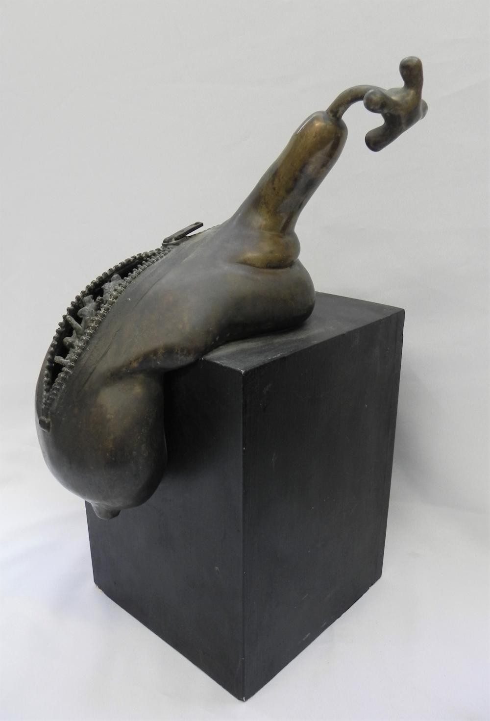 Zip, a bronze shell form with zip teeth along its opening and a small tap on top, on a black plinth, by David Hamilton