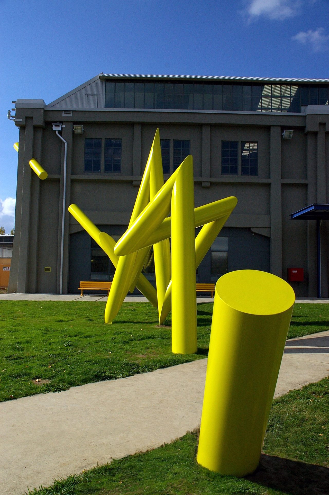 Bolt, angular yellow steel rods radiating from a grassed traffic island near the Academy of the Arts, by David Hamilton