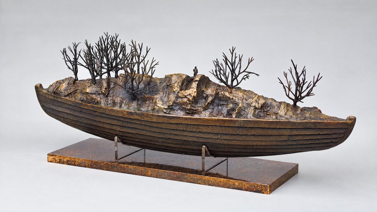 Last River Boat, a bronze boat carrying a rocky, tree-lined shore with a tiny standing figure, by David Hamilton